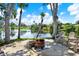 Charming backyard with waterfront views featuring outdoor seating and fire pit at 5473 Bayshore Dr, Seminole, FL 33772