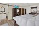 Bedroom featuring a large king bed, wood floors, closet, and access to an en-suite bathroom at 5473 Bayshore Dr, Seminole, FL 33772