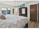 Bright bedroom with a king-size bed and sliding glass doors leading to a patio with a pool view at 5473 Bayshore Dr, Seminole, FL 33772