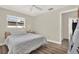 Comfortable bedroom featuring a queen bed with hardwood floors, a window with natural light, and modern decor at 5473 Bayshore Dr, Seminole, FL 33772