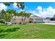 Exterior of home showcasing a well-manicured lawn and lush landscaping at 5473 Bayshore Dr, Seminole, FL 33772