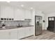 Modern kitchen with granite counters, stainless fridge, updated cabinets and stylish mosaic backsplash at 5473 Bayshore Dr, Seminole, FL 33772