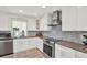 Kitchen boasts granite counters, stainless appliances, a decorative backsplash, and ample natural light at 5473 Bayshore Dr, Seminole, FL 33772