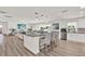 Modern kitchen island with bar seating and view into the living room and backyard at 5473 Bayshore Dr, Seminole, FL 33772
