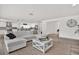 Comfortable living room with a large sectional sofa and view of the updated kitchen at 5473 Bayshore Dr, Seminole, FL 33772