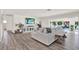 Inviting living room with an entertainment center and sliding door access to the pool at 5473 Bayshore Dr, Seminole, FL 33772