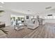 Open-concept living room with views of the kitchen and pool area, perfect for entertaining at 5473 Bayshore Dr, Seminole, FL 33772