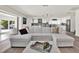 Bright, open living area with a view of the modern kitchen and access to the outdoor space at 5473 Bayshore Dr, Seminole, FL 33772