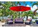 Charming outdoor patio with wicker furniture set, large umbrella and water views at 5473 Bayshore Dr, Seminole, FL 33772