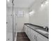 Modern bathroom showcasing a double vanity, sleek fixtures, and a frameless glass shower at 5707 N 20Th St, Tampa, FL 33610