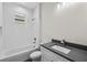 Bathroom featuring subway tile shower, modern vanity with gray countertop, and updated fixtures at 5707 N 20Th St, Tampa, FL 33610