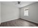 Neutral bedroom showcasing gray floors, ample natural light, and a modern ceiling fan at 5707 N 20Th St, Tampa, FL 33610