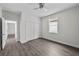 Bedroom with gray floors, double closet, and doorway leading to another room at 5707 N 20Th St, Tampa, FL 33610