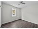 A comfortable bedroom featuring a ceiling fan, window, and ample natural lighting at 5707 N 20Th St, Tampa, FL 33610