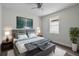 Comfortable bedroom features modern ceiling fan, art, wood-look floors, and a plush rug at 5707 N 20Th St, Tampa, FL 33610