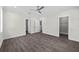 Bright bedroom features wood floors, a ceiling fan, and a walk-in closet for ample storage at 5707 N 20Th St, Tampa, FL 33610