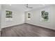 Airy bedroom with hardwood floors, neutral walls, recessed lighting, and three large windows at 5707 N 20Th St, Tampa, FL 33610