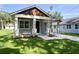 Gorgeous facade with freshly installed landscaping, concrete driveway, and covered portico and porch at 5707 N 20Th St, Tampa, FL 33610