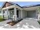 Charming home exterior featuring an inviting front porch, covered parking, and well-manicured landscaping at 5707 N 20Th St, Tampa, FL 33610