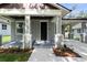 Inviting front porch with neutral tones and manicured landscaping enhances the curb appeal at 5707 N 20Th St, Tampa, FL 33610