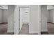 Hallway showing an open doorway into a bathroom with white subway tile and updated fixtures at 5707 N 20Th St, Tampa, FL 33610
