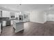 Spacious kitchen with stainless appliances, an island, white cabinets, and ample natural light at 5707 N 20Th St, Tampa, FL 33610