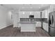 Modern kitchen features white cabinets, stainless steel appliances, gray countertops, and stylish backsplash at 5707 N 20Th St, Tampa, FL 33610