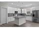 A kitchen features an island, stainless appliances, and subway tile backsplash at 5707 N 20Th St, Tampa, FL 33610