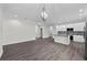 An open kitchen features stainless steel appliances, an island, and white cabinets at 5707 N 20Th St, Tampa, FL 33610