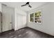A bedroom features dark wood flooring, crisp white trim, neutral walls, a window and closet for storage at 5709 N 20Th St, Tampa, FL 33610