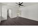 A bedroom features sleek wood flooring, crisp white trim, neutral walls, and doorways to ensuite bathroom and closet at 5709 N 20Th St, Tampa, FL 33610