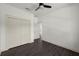 A bedroom boasts dark wood flooring, crisp white trim, neutral walls, and doorways to closet and hallway at 5709 N 20Th St, Tampa, FL 33610