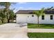 Beautiful home exterior with a two-car garage, wide driveway, and palm tree at 5709 N 20Th St, Tampa, FL 33610