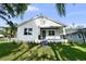 Charming home featuring lush lawn, manicured landscaping, and inviting front porch at 5709 N 20Th St, Tampa, FL 33610