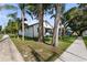 Street view capturing the home's curb appeal with a well-kept lawn and sidewalk at 5709 N 20Th St, Tampa, FL 33610