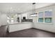 Bright kitchen with white cabinets, quartz countertops, backsplash, and stainless steel appliances at 5709 N 20Th St, Tampa, FL 33610