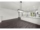 Modern kitchen featuring white cabinets, quartz countertops, and stainless-steel appliances, open to living space at 5709 N 20Th St, Tampa, FL 33610