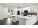 Well-lit kitchen featuring a large island, stainless steel appliances, and white cabinetry at 5709 N 20Th St, Tampa, FL 33610