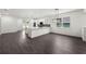 Modern kitchen featuring white cabinets, a breakfast bar, and an open view of the living area at 5709 N 20Th St, Tampa, FL 33610