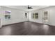 Open-concept living area featuring dark wood floors and white trim, next to modern kitchen area at 5709 N 20Th St, Tampa, FL 33610
