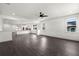 Bright open-concept living room with dark wood floors leading to the kitchen and dining area at 5709 N 20Th St, Tampa, FL 33610