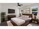 Beautiful main bedroom with rustic wood bed frame, TV, and stylish decor at 5709 N 20Th St, Tampa, FL 33610