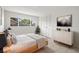 Cozy bedroom with comfortable bedding, modern dresser, and large window offering natural light at 6236 17Th S St, St Petersburg, FL 33712