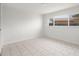 Bright bedroom with tile floor, a large window, and fresh white walls for a clean, modern look at 6236 17Th S St, St Petersburg, FL 33712