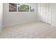 This bright, airy bedroom features tile floors, a large window, and closet with folding doors at 6236 17Th S St, St Petersburg, FL 33712