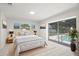Bright bedroom featuring sliding glass doors to a screened pool area and neutral decor at 6236 17Th S St, St Petersburg, FL 33712