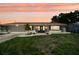Charming single-story home with a well-manicured lawn and a welcoming front entrance at sunset at 6236 17Th S St, St Petersburg, FL 33712