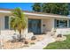 Inviting home exterior with a well-maintained front yard, featuring a palm tree and appealing landscaping at 6236 17Th S St, St Petersburg, FL 33712