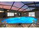 Inviting screened-in pool area featuring a sparkling pool, perfect for relaxation and entertaining at 6236 17Th S St, St Petersburg, FL 33712