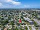 Vast aerial perspective showcasing a suburban area extending towards the ocean, marked by a prominent pin for property location at 6554 34Th N Ave, St Petersburg, FL 33710